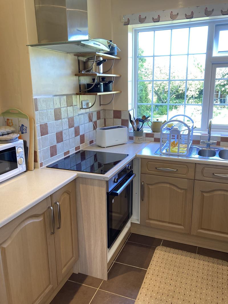 kitchen with induction hob and electric oven